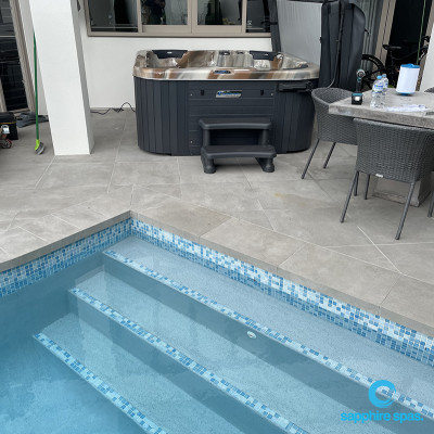 Warm spa pool nestled beside this azure blue swimming pool thanks to the team @ Paramount Pools Takapuna